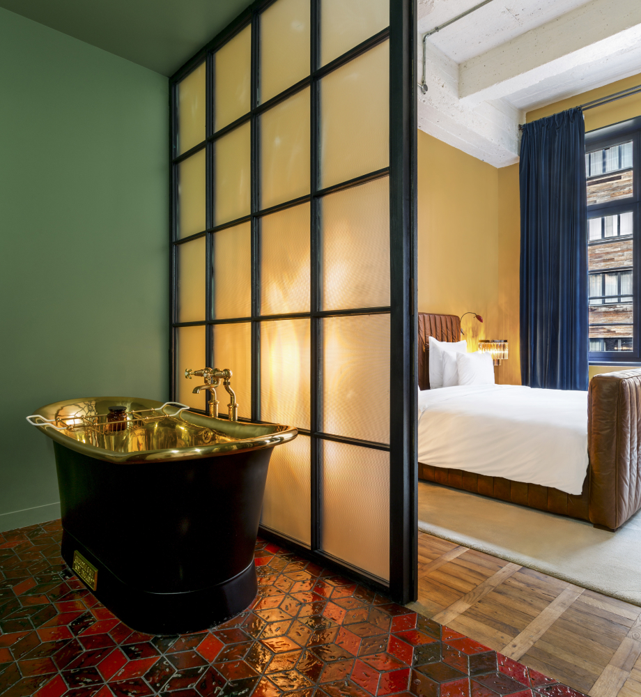 stamba hotel aviator suite room bathroom with golden bathtub