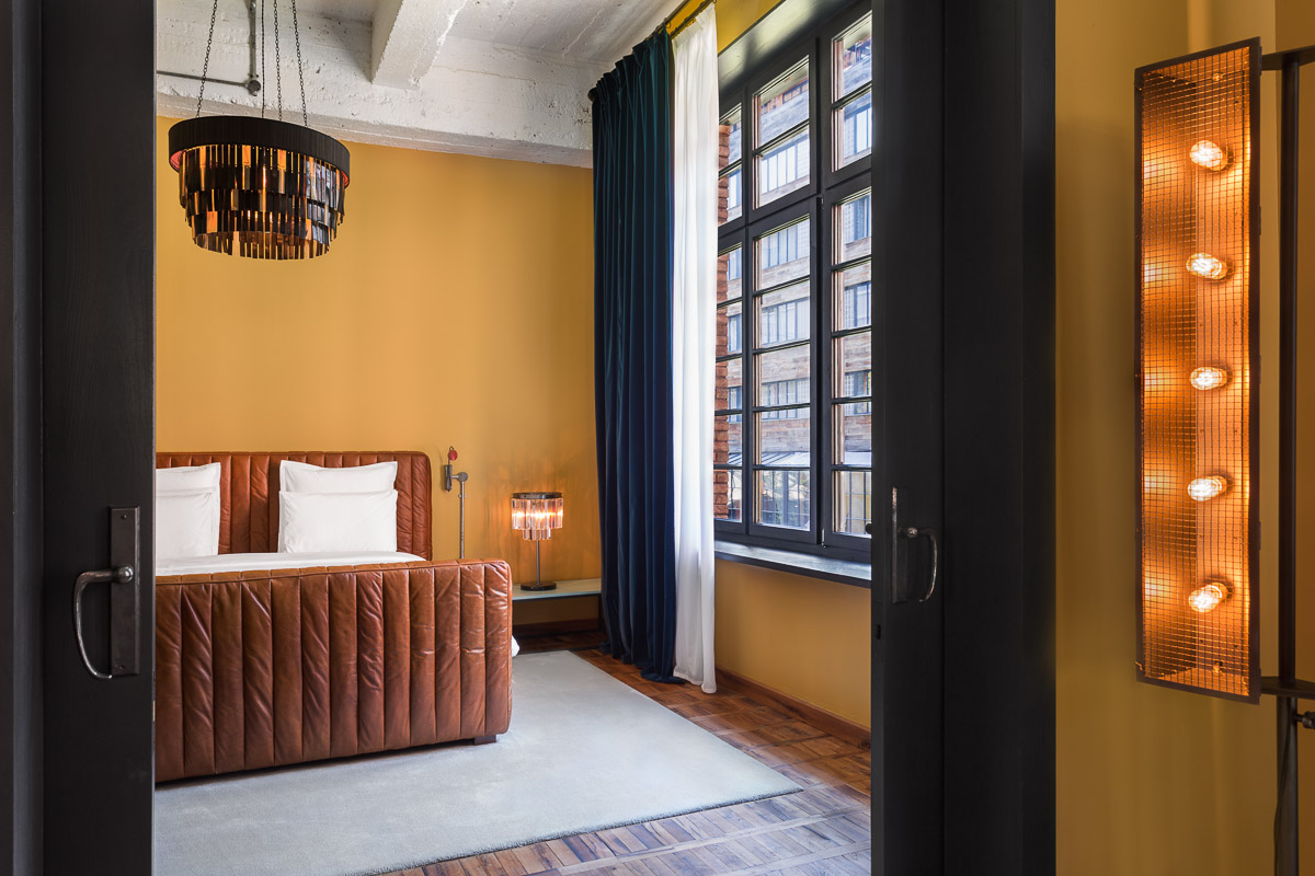 stamba hotel aviator suite room bed next to wide window